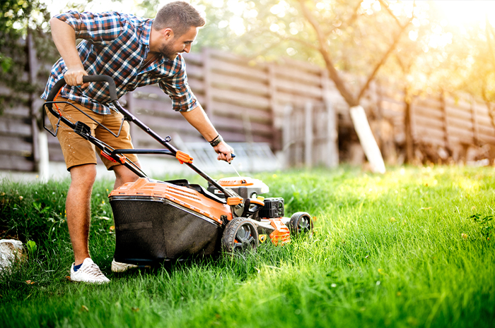 homeowner starting a lawnmower