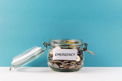 jar full of coins, labeled 'Emergency'