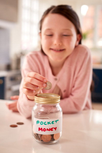 Girl putting money in jar
