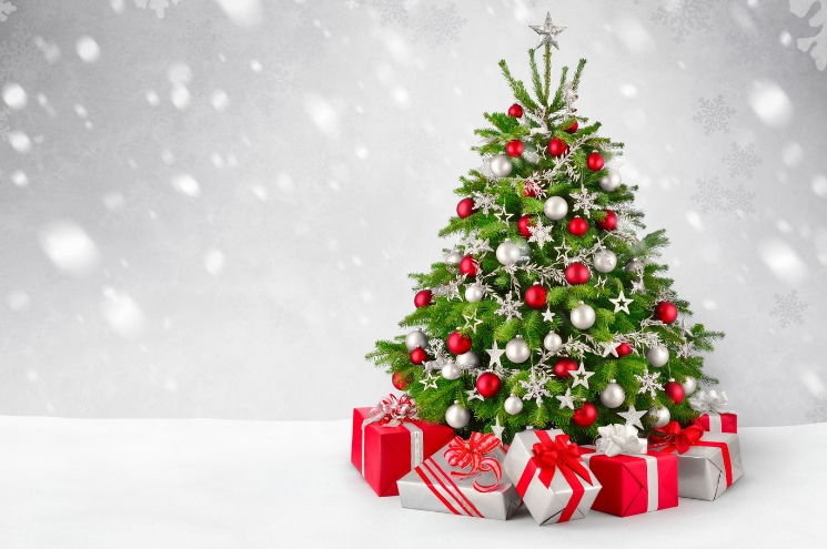 snowy scene with Christmas tree and wrapped gifts