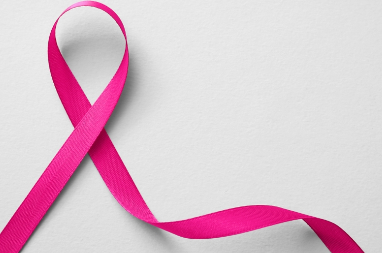 pink cancer ribbon on gray background