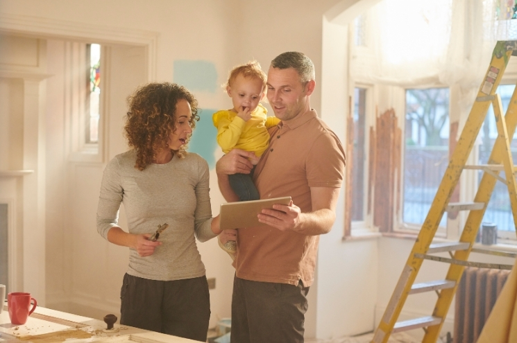 husband and wife look over remodel plans