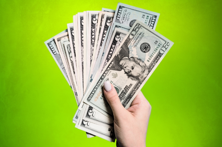 hand holding currency bills