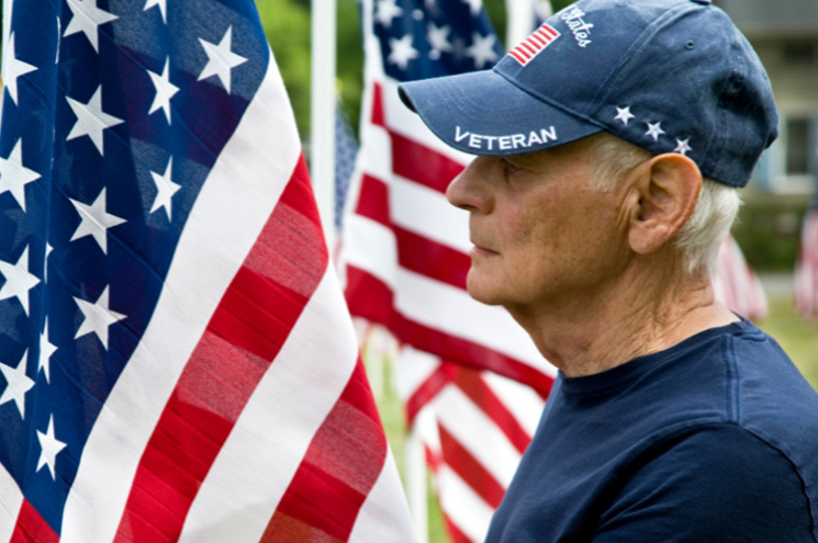 United States Veteran near standing flags
