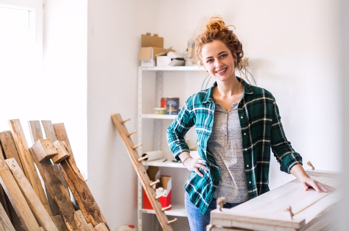 woman in a new office or retail space installing shelving