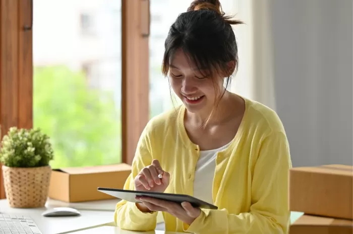 woman smiling while using phone for banking