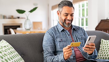 Man with mobile phone and check card