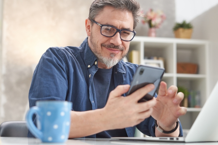 man tapping on a phone screen