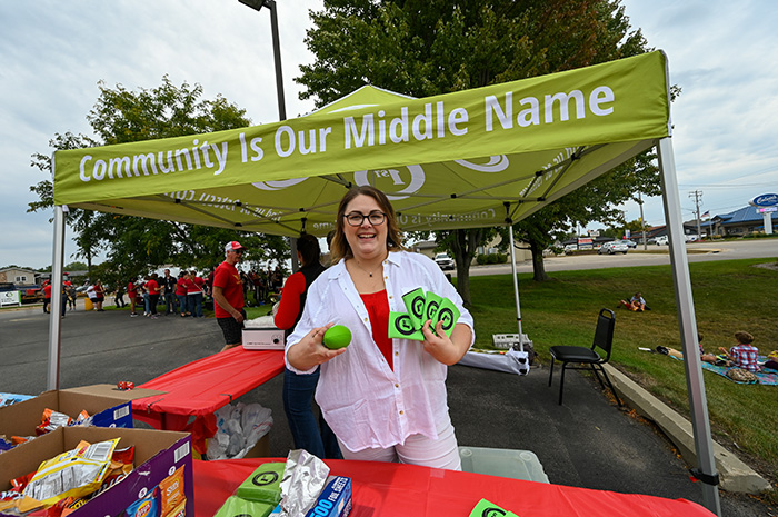 Janet handing out football and coozies